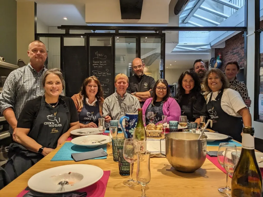 Link Paris customers enjoying a private cooking class at the Cook'n With Class kitchen in Paris